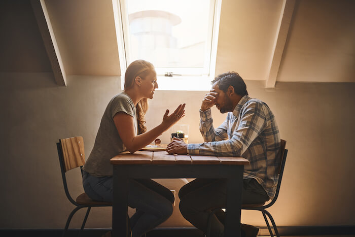 man and woman sitting at table talking effects of emotional abuse