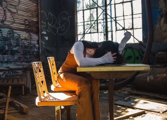 woman sad laying head on desk why is life so hard