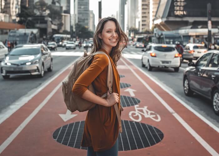 woman standing in busy street quotes about sacrifice