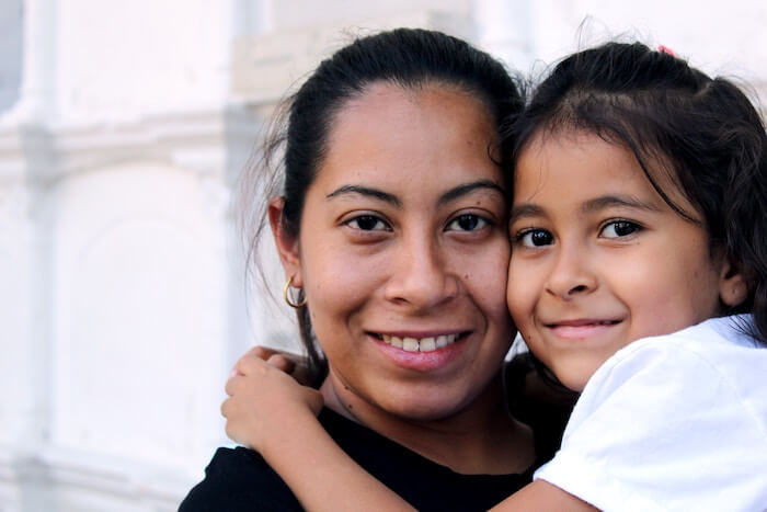 woman holding daughter smiling mothers day messages