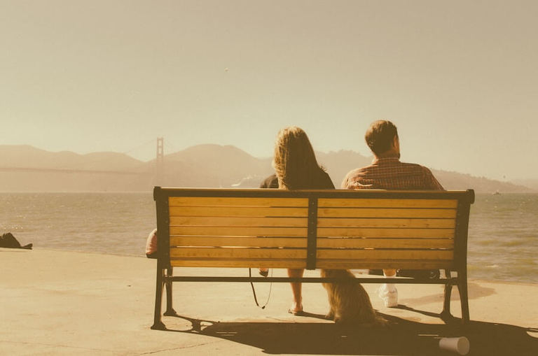 man and woman sitting bench taking a break in a relationship