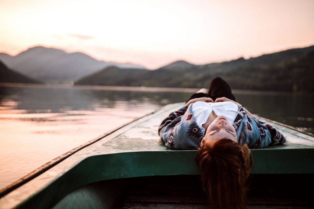 woman resting on boat, emotional self care