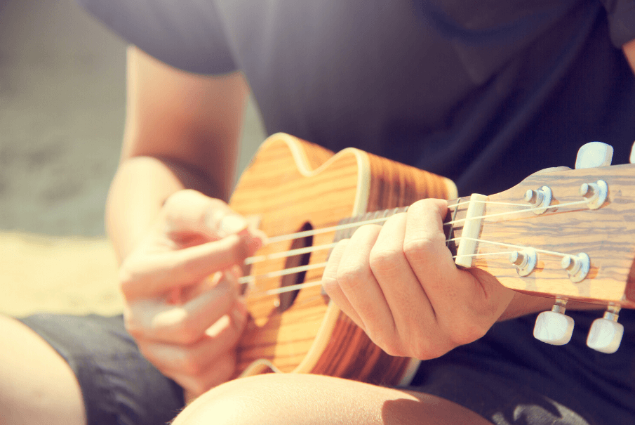 man playing guitar, cheap hobbies