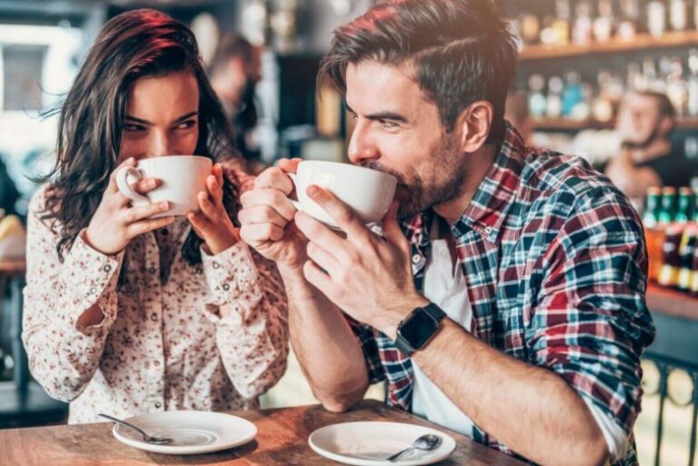 couple drinking coffee, flirty questions to ask a guy