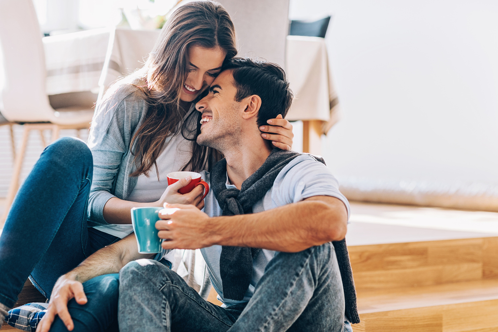 couple hugging with coffee signs she wants a serious relationship with you