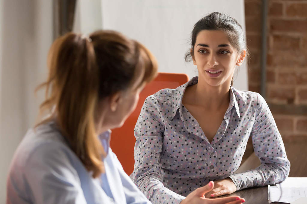 women talking at desk how to deal with disrespect