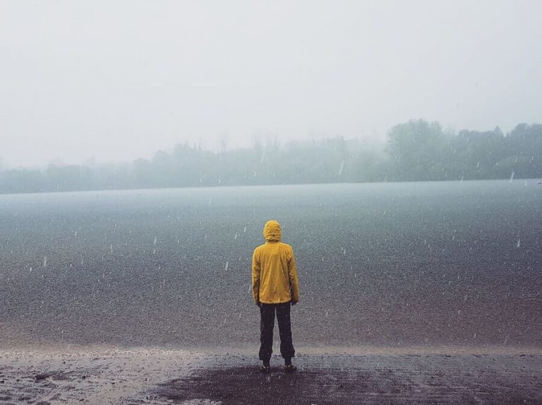 man standing by lake in rain Packable Rain Jackets for Men