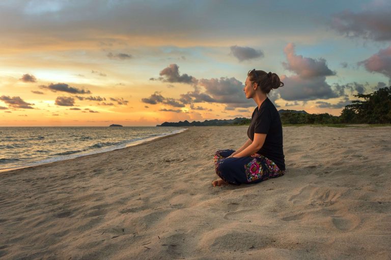 woman sitting on beach, universal truths