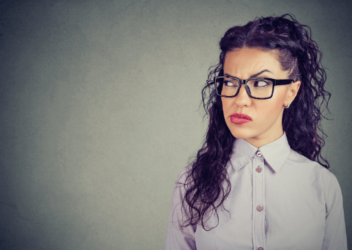 woman headshot with suspicious face signs a woman is jealous of another woman