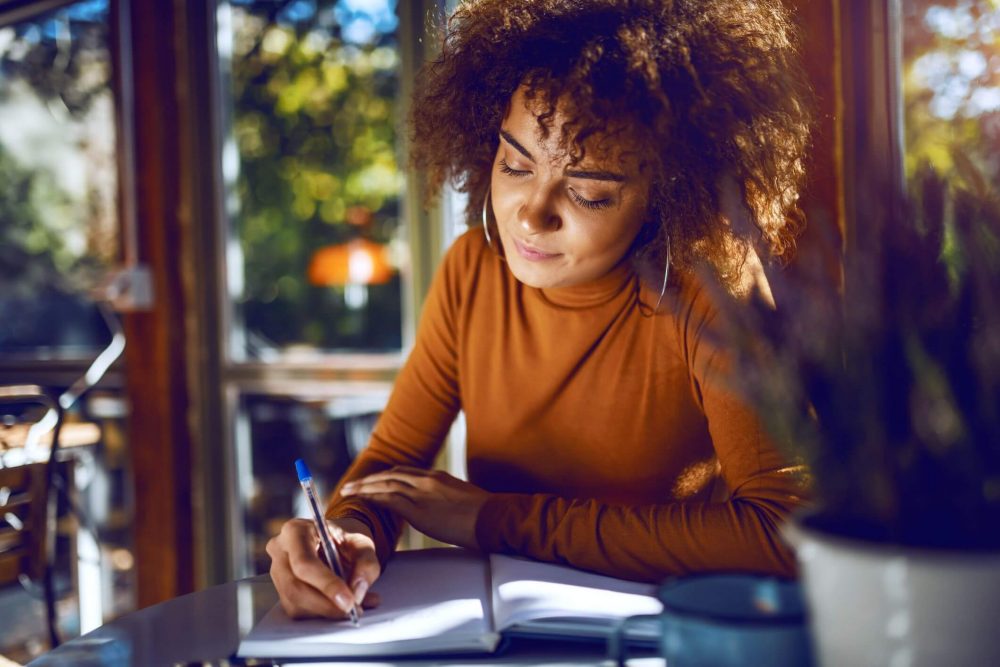 woman writing, mottos to live by