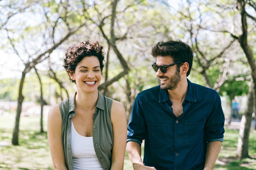 couple laughing outside icebreaker questions for dating