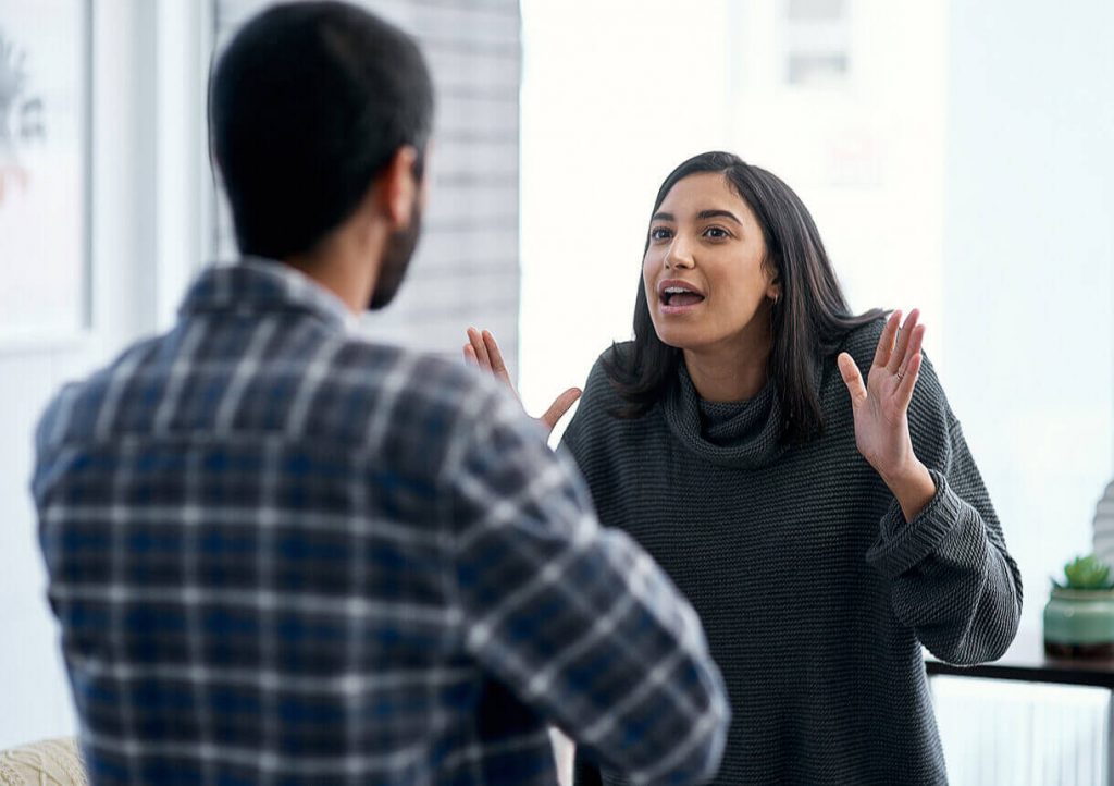 woman talking to man intensely what to do when someone lies to you in a relationship