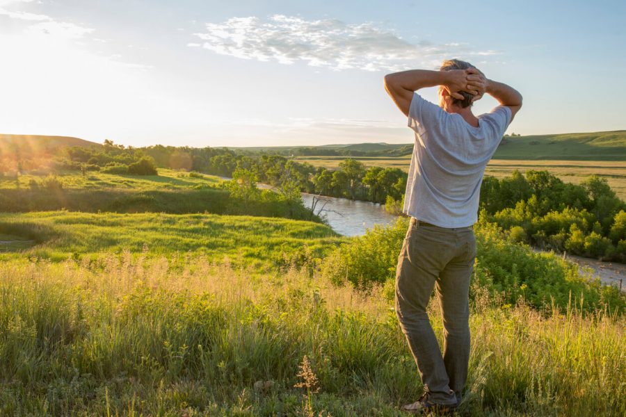 Man enjoys looking at sunset signs from the universe that someone is thinking of you