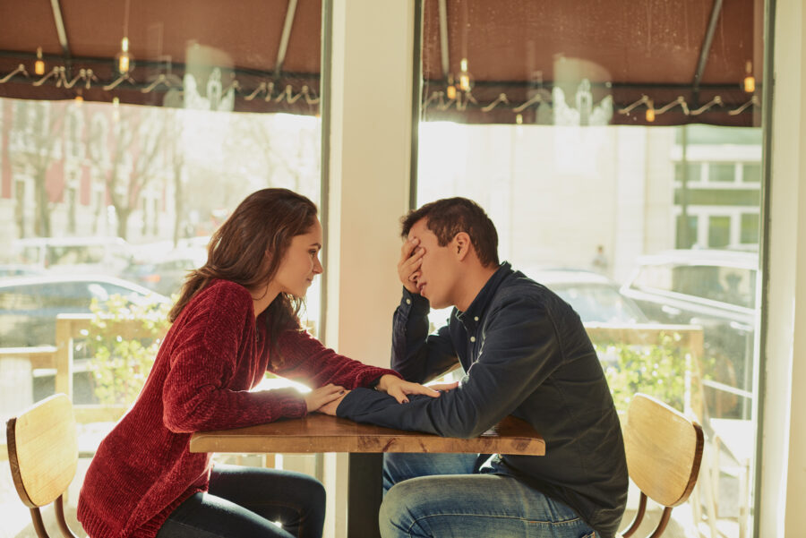 young man and woman talking at a coffee shop deal breakers in a relationship