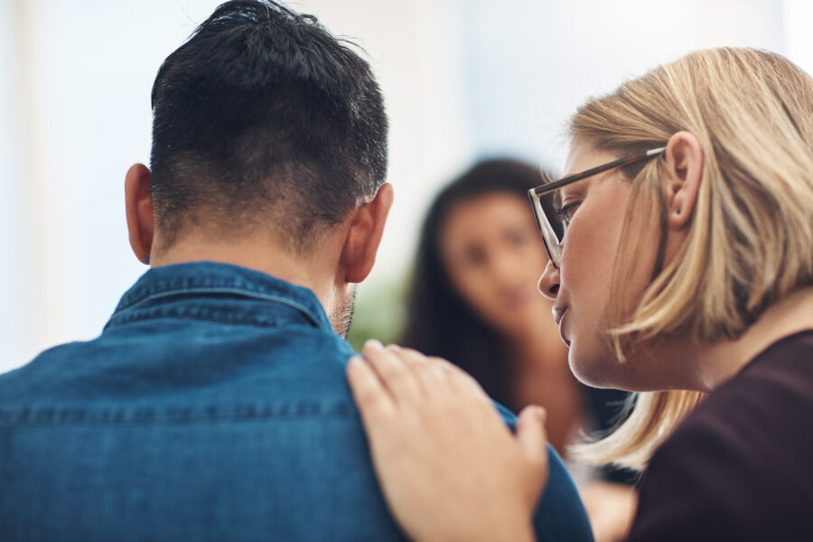 husband and wife whispering about something signs your family doesn’t care about you