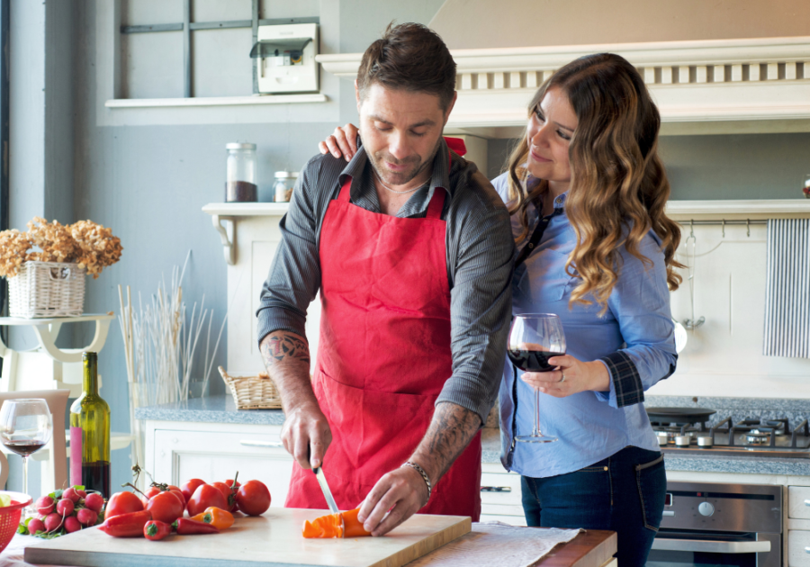 couple being sweet while cooking interdependent relationship