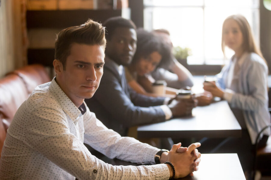 people looking at an alone man in cafe how to stop being toxic