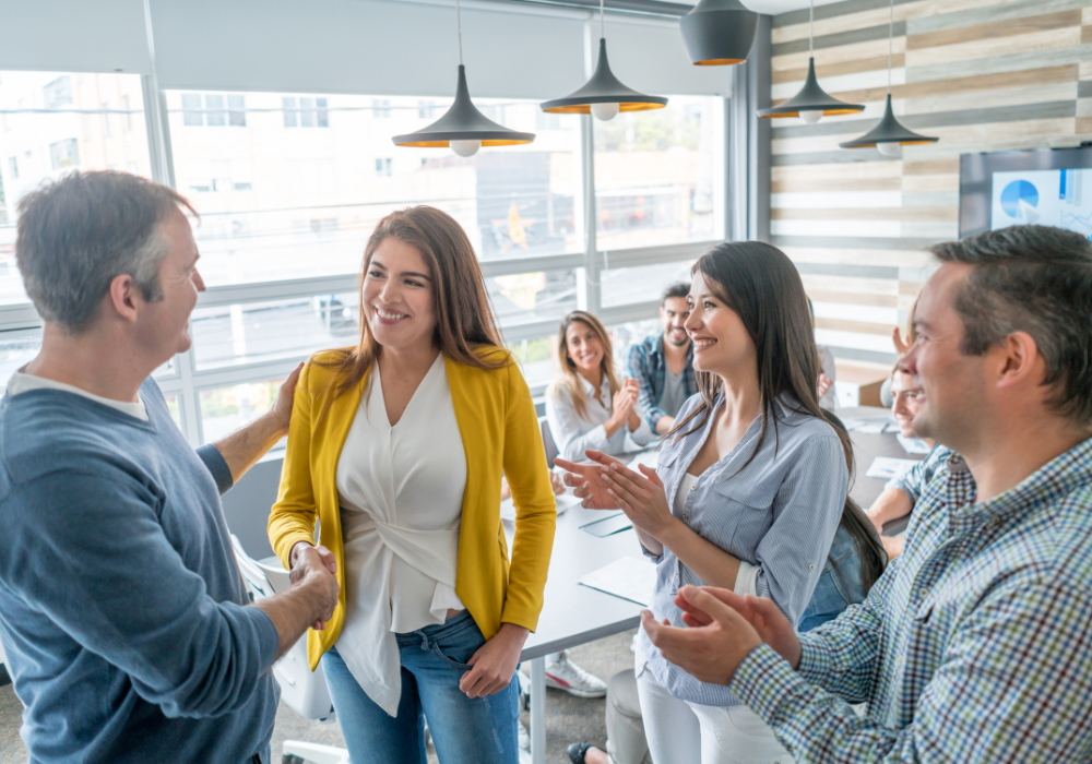 Workmates congratulating an officemate affirmations for success