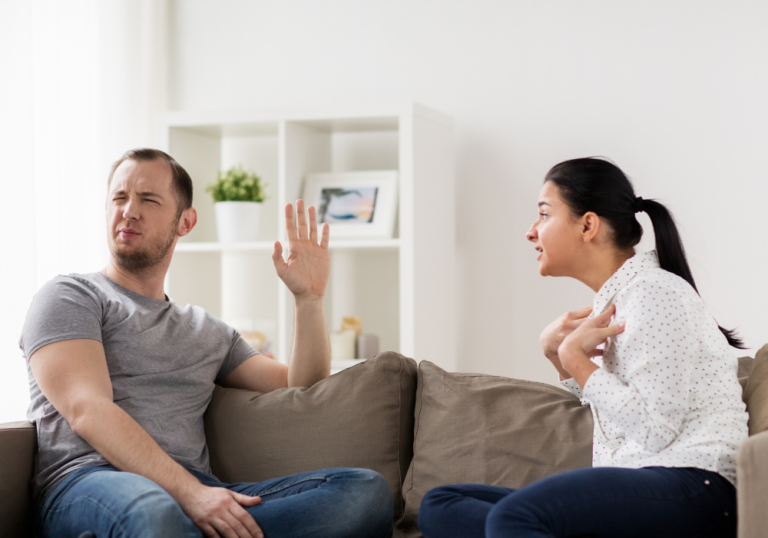 married couple arguing in the sofa signs of emotional invalidation in your relationship