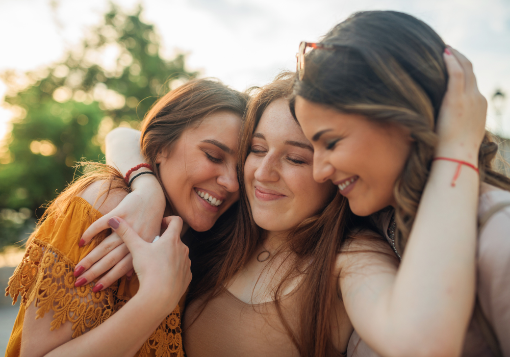 three best friends hugging warm personality