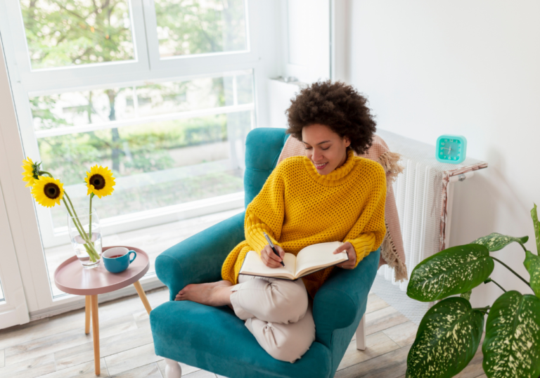 woman in yellow writing emotional goals