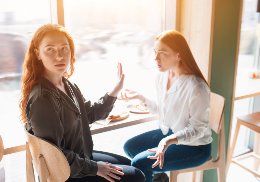 girl dismissing her friend while talking signs of an emotionally draining person