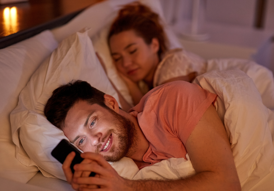 man happily texting while wife is sleeping why do I attract married men