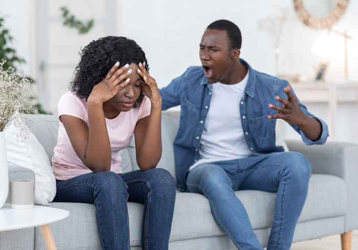 couple sitting on sofa man is angry my husband yells at me