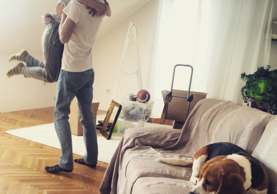 young couple sweet and playful in the living room questions to ask before moving in together