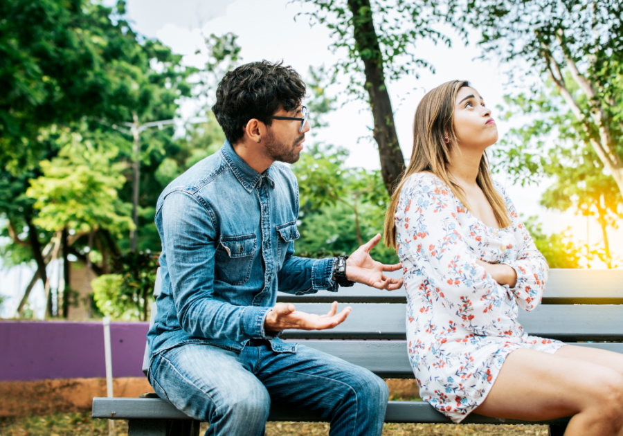 young couple having an argument in the park signs of contempt in relationships