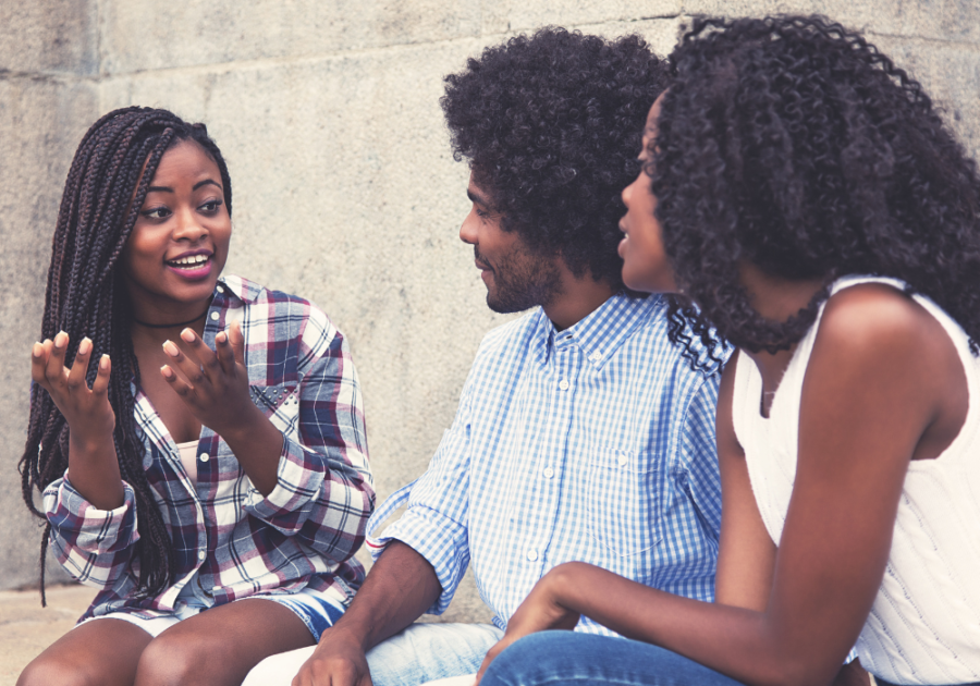 group of friends sitting talking Red Flags In Friendships