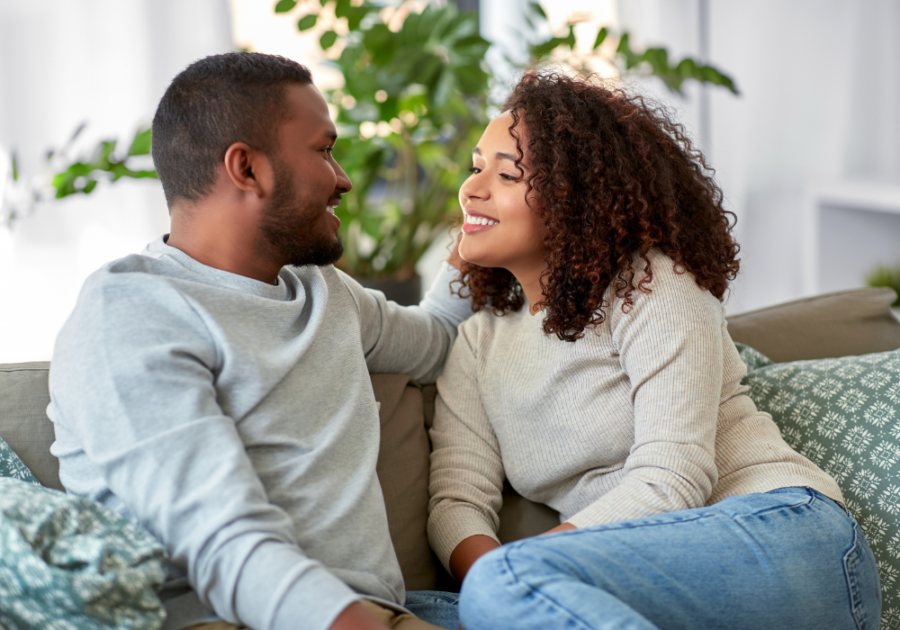 couple sitting on sofa talking questions to ask your boyfriend to test his love