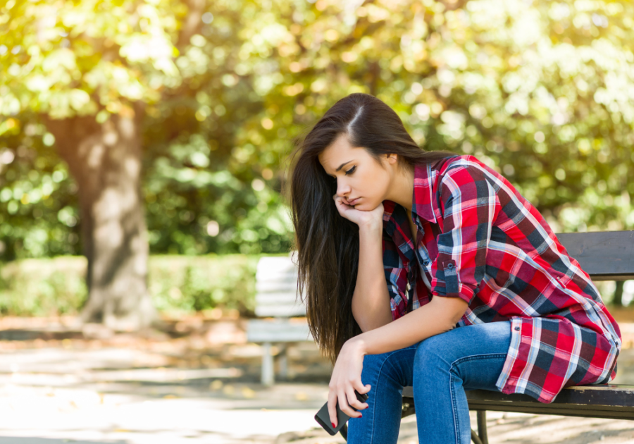 woman thinking hard sitting on bench signs the relationship is over for him