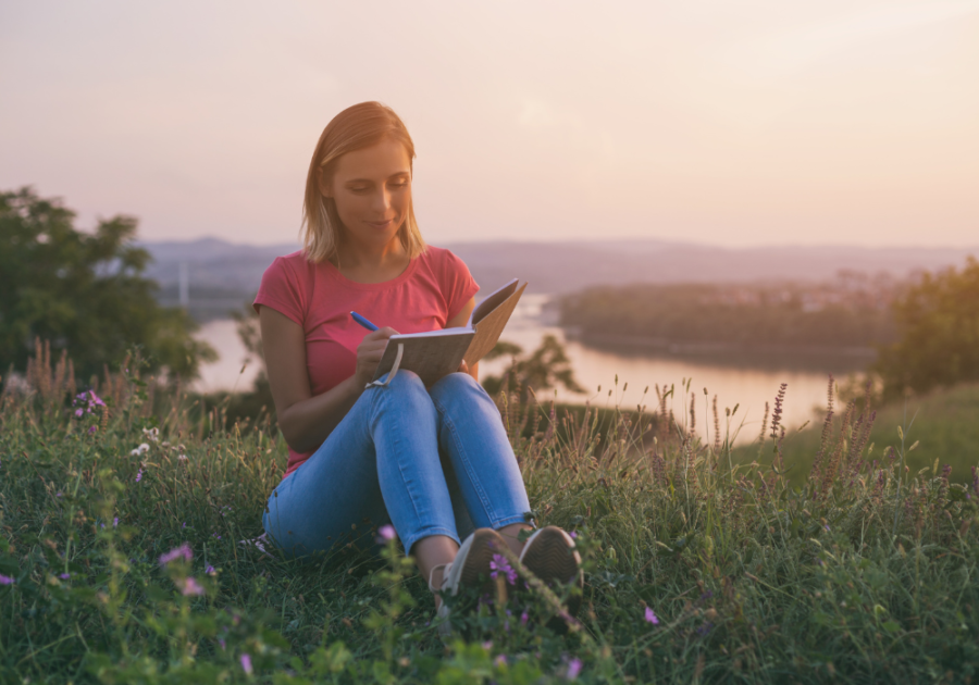 woman near the lake writing in notebook 365 reasons why i love you list