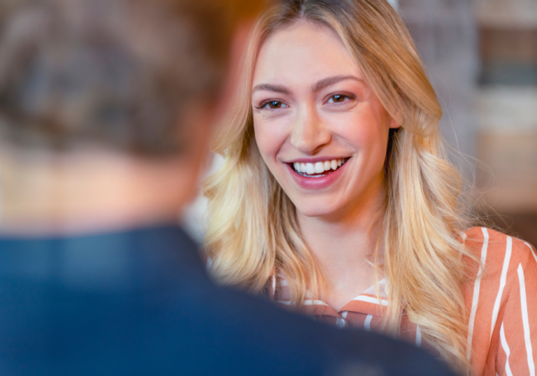 happy woman talking with a man how to get a guy to ask you out