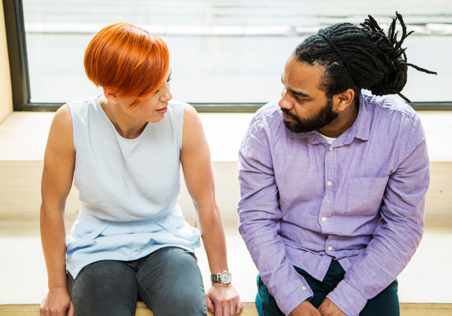 man and woman talking intently how to get a guy to ask you out