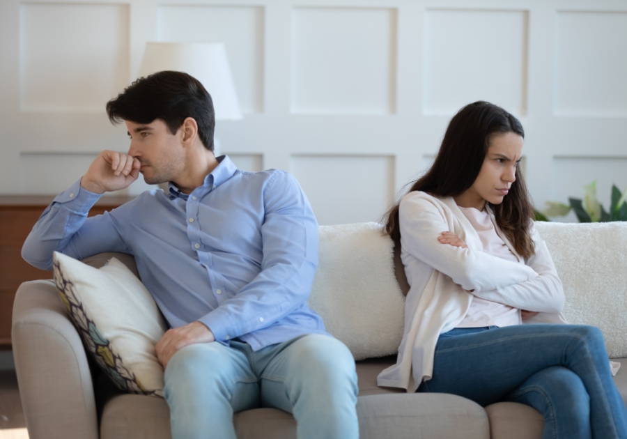 man and woman sitting on sofa not talking silent red flags in a relationship