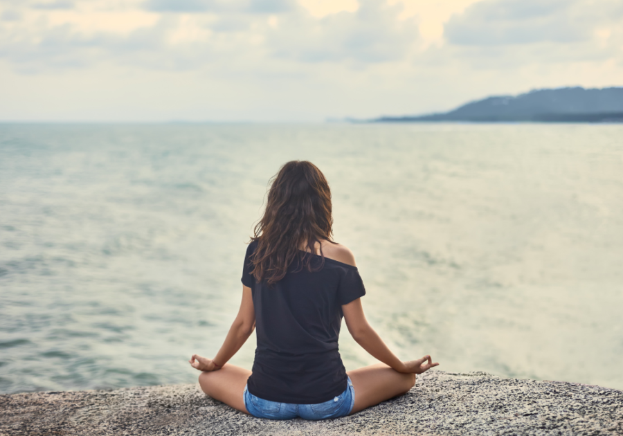 girl meditating by the seaside signs twin flame separation is almost over