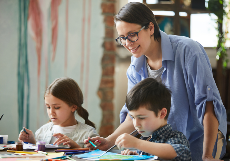 mom helping her kids with art