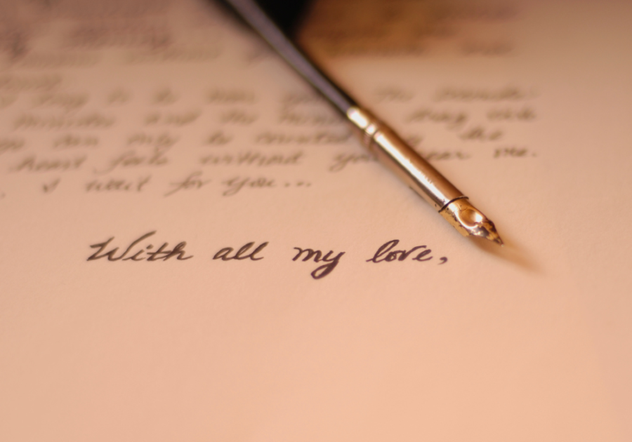 pen and paper with a love letter letter to husband on wedding day