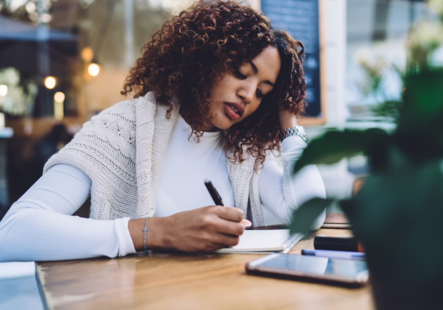 woman being serious while writing 365 reasons why i love you list