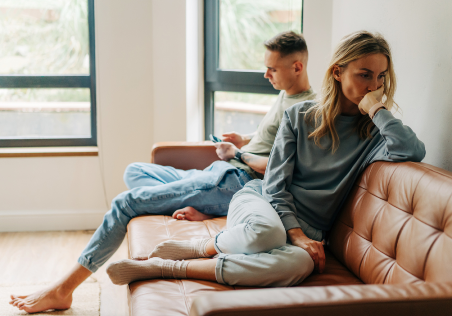 couple sitting down in couch feeling like an option in a relationship