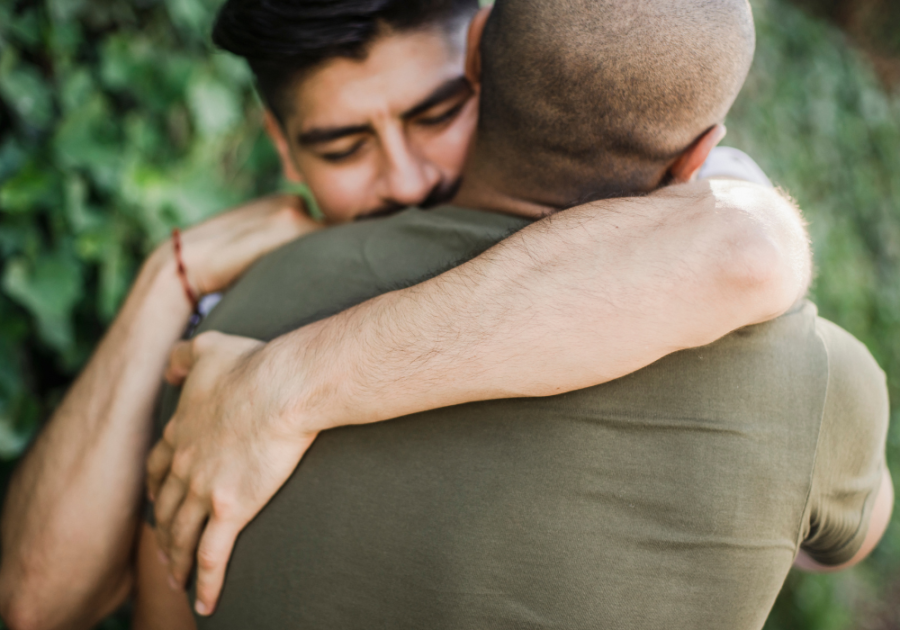 two guys hugging each other how many hugs we need each day