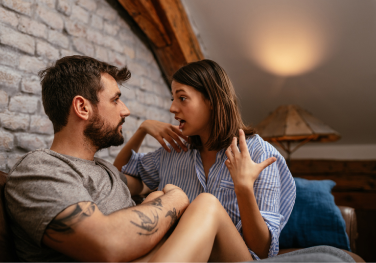 woman talking to man while sitting in couch psychological effects of false allegations in a relationship