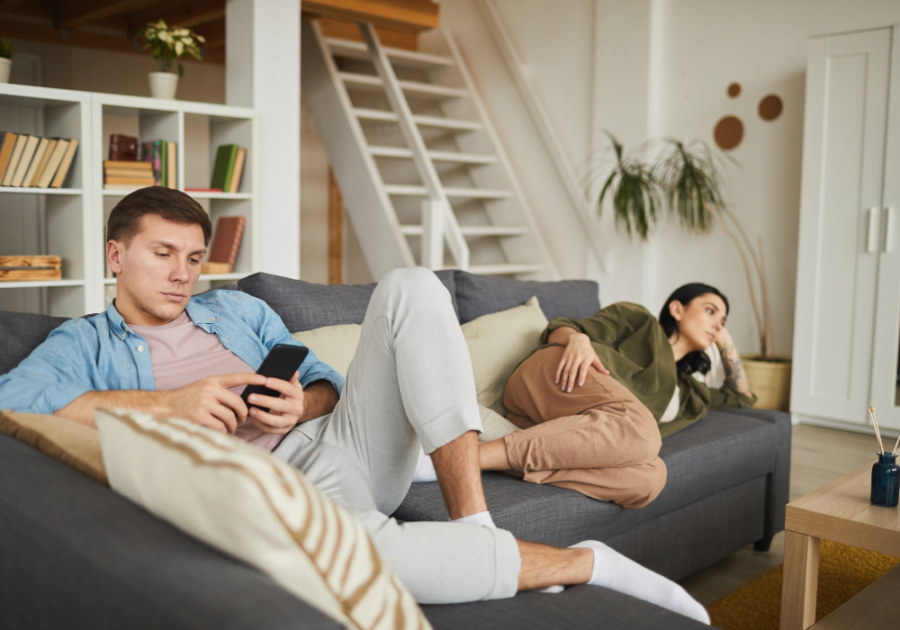 man and woman lounging in the couch bare minimum in a relationship