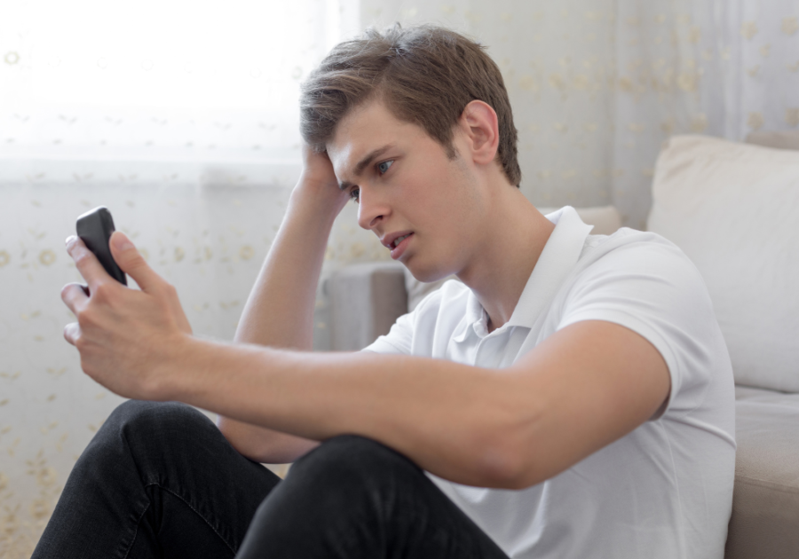 man looking at phone intently no response is a response