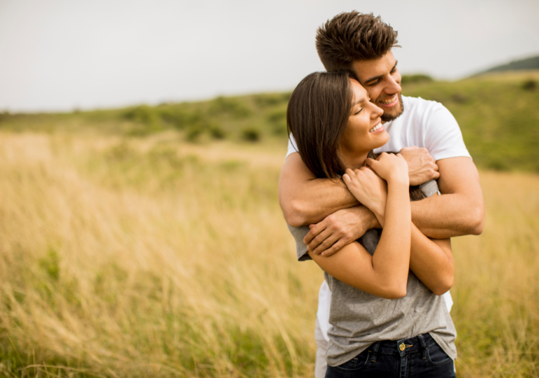 sweet couple hugging each other in the field signs a cancer man is serious about you