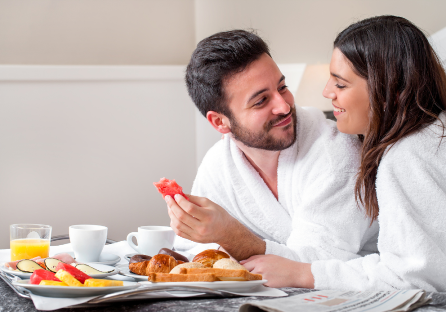 couple in robes eating breakfast Romantic Hotel Room Ideas for Her 