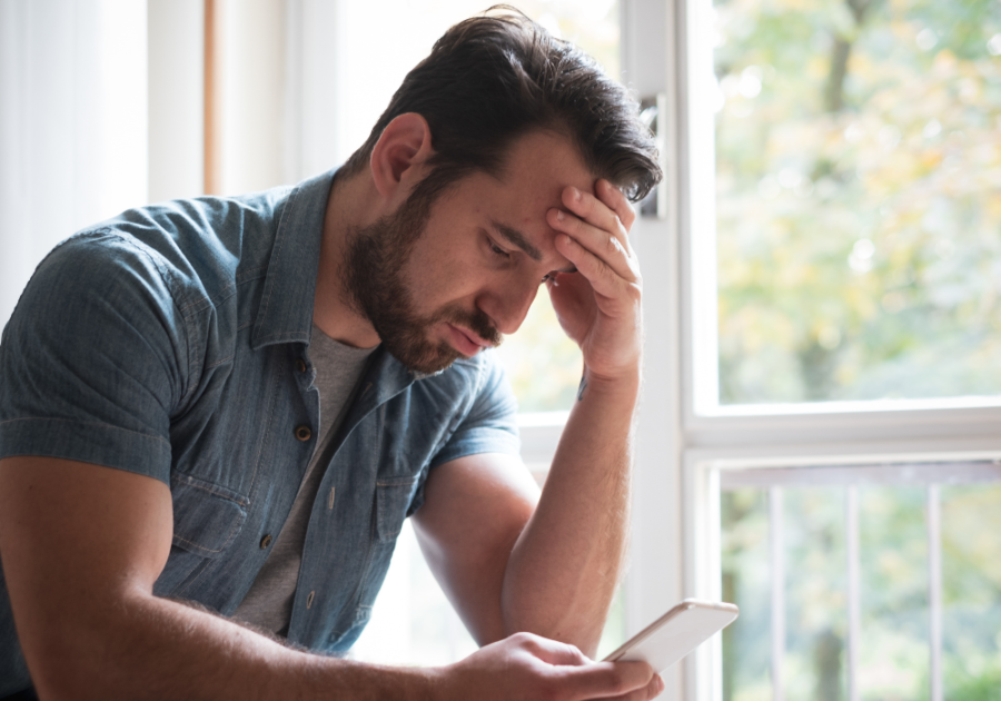 man reading something on his phone how to respond to a breakup text