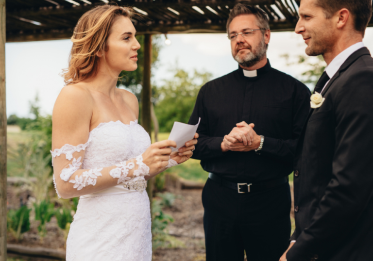 woman in wedding gown holding paper romantic wedding vows to make him cry